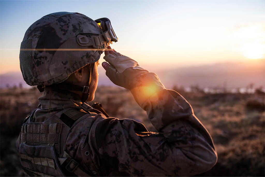 Marine in tactical gear saluting 